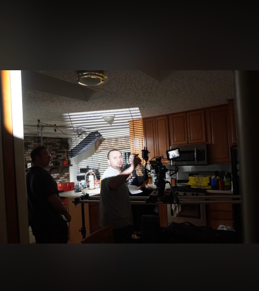 Director blocking a scene in a kitchen lit with practical and shaped lighting