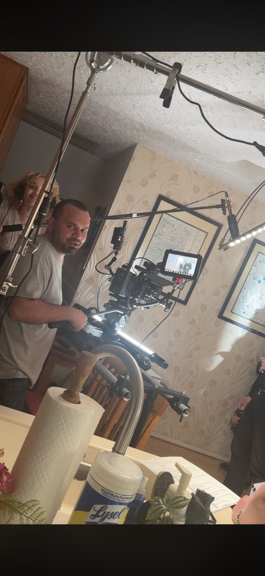Operator behind a cinema camera on a slider during an interior shoot