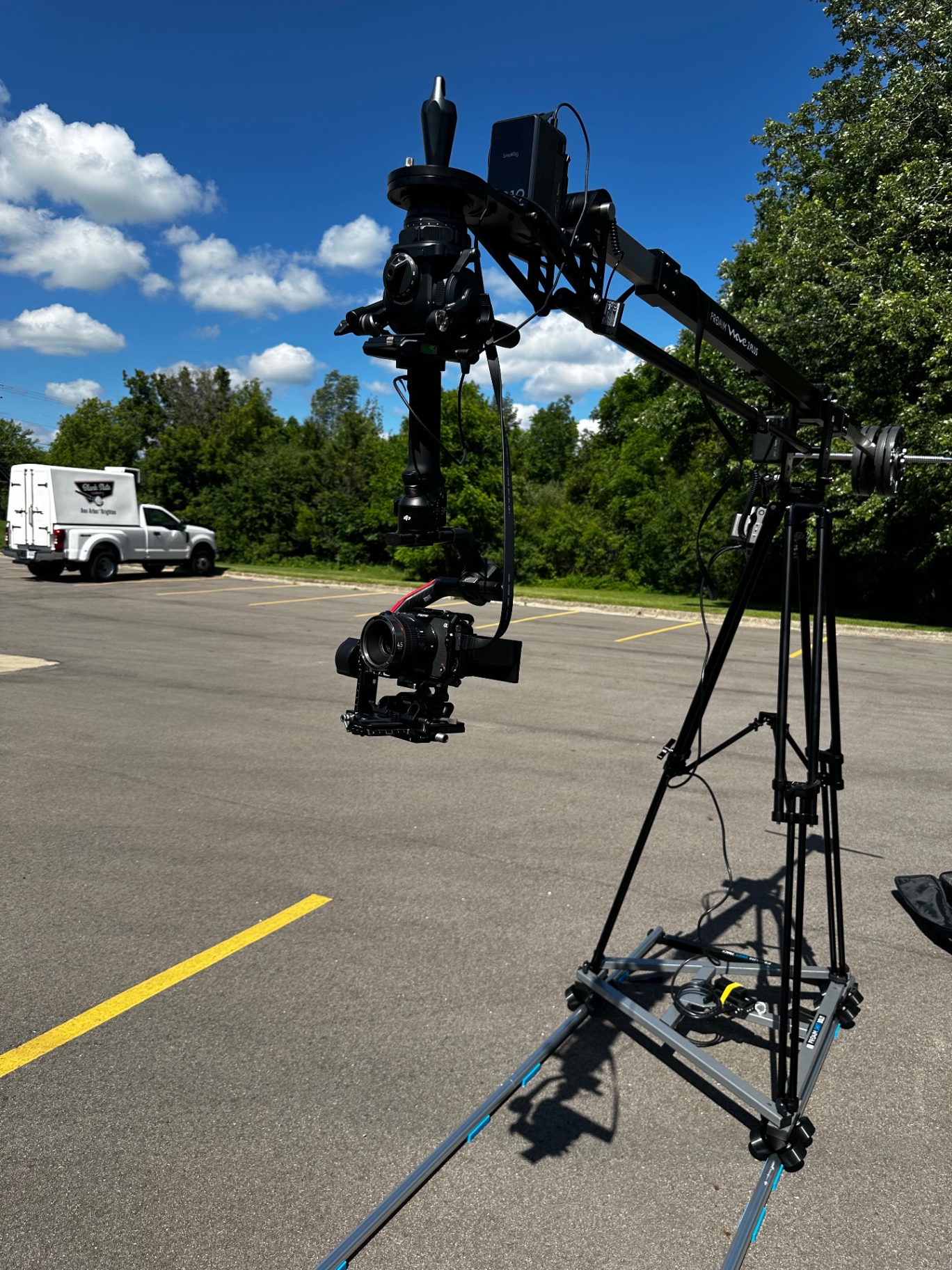 Camera on a gimbal suspended from a jib arm on location outdoors